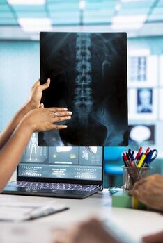General practitioner and old patients engaging in a discussion with diagnostic reports via x ray imaging results for scan interpretation. Medical staff showcasing healthcare practices. Close up. photo