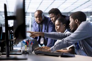 Data center coworkers doing brainstorming, creating technical documentation for software applications. IT colleagues collaborating, working together in server room maintaining databases photo