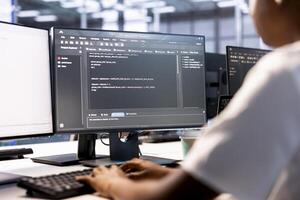 Cybersecurity worker monitoring security incidents affecting server farm network. Computer scientist in data center protecting company critical infrastructure from cyber threats photo