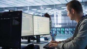 System administrator in server room doing system analysis, coding supercomputers. Specialist working in high tech facility housing advanced storage infrastructure, camera B close up photo
