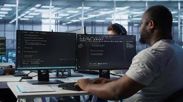 Admin in server hub tasked with protecting valuable data against hacking attack on computers. African american worker safeguarding data center against unauthorized access and vulnerabilities, camera B photo