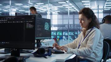 Joyful technician working in high tech workspace providing computing resources for different workloads. Relaxed woman tasked with monitoring data center supercomputers, camera B photo