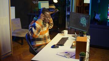 African american man working on computer to write code and programming in artificial intelligence and deep learning. Male IT engineer using pc to ensure cyber security, neural network. Camera B. photo
