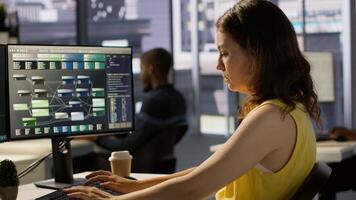 IT employee coding in programming languages to construct algorithms and build applications. Software technician developing and maintaining databases and data structures in office, camera A photo