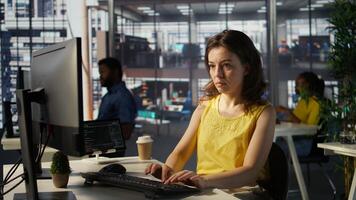 Portrait of smiling programmer creating machine learning models that can process and analyze data to automate decision making processes. Cheerful IT professional programming in office, camera B photo