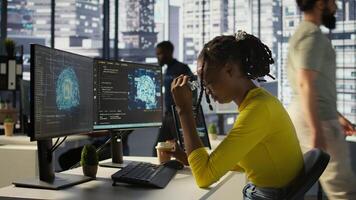 Staff member in office yawning during shift, feeling tired while looking at artificial intelligence software on PC. Exhausted african american AI company employee being sleepy in workspace, camera B photo
