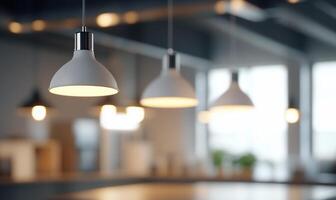 Modern pendant lights illuminate a stylish workspace setting. photo