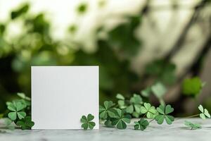 close-up mockup white blank empty paper card with green shamrocks on blurred background, st Patrick day template for design photo