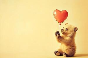 cute fluffy bear cub holding red heart-shaped balloon on light yellow background with copy space, romantic valentines day postcard photo