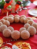 Sweet Sesame Balls on Red Tablecloth. photo