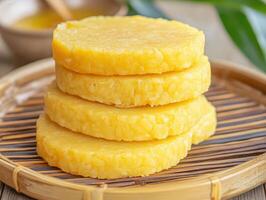 Stack of Yellow Cakes on a Bamboo Platter. photo