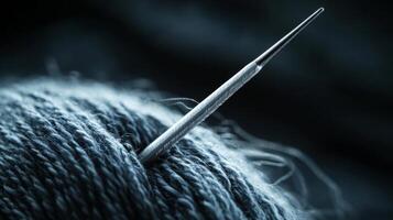Close-up of a Needle in a Ball of Yarn. photo