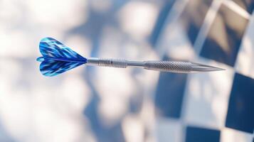 Close-up of a steel dart with blue flights against a checkered background photo