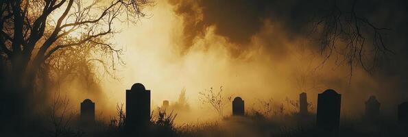 Mysterious foggy graveyard with silhouetted tombstones and bare trees at dawn photo