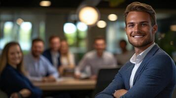 Confident Young Man Smiling in Modern Office Setting with Colleagues photo