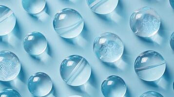 Crystal Clear Spheres on Soft Blue Surface Creating a Serene and Tranquil Background with Soft Light Reflection and Distinct Shadow Patterns photo