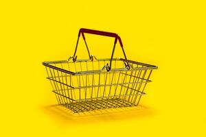 empty shopping cart on yellow background photo