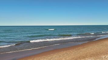 Aerial view Tranquil Sandy Beach and Calm Ocean Waves, Serene sea view with gentle waves, video