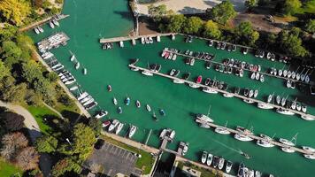 Aerial View Sheridan Shore Yacht Club of Boats in Marina, A vibrant aerial view of boats docked in a marina surrounded by greenery. video