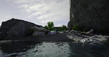 Scenic coastal landscape with rocks and serene water under cloudy sky video
