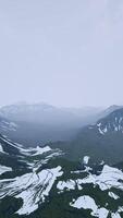 Awesome top view through clouds to high snowy mountains video