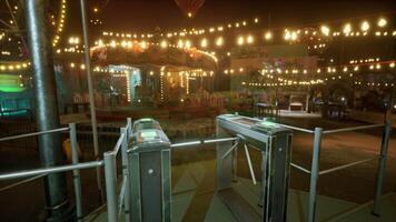 Empty amusement park at night with bright lights and deserted attractions video