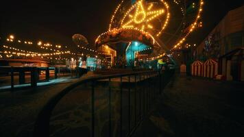 An empty amusement park filled with colorful lights at night video