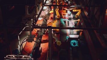 Automated conveyor system with robotic arms operating in a factory at night video