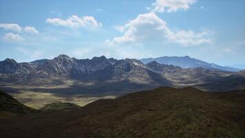 Majestic mountain range under a clear blue sky in daytime landscape video
