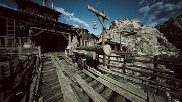 Old wooden bridge leading to rustic mining settlement in a mountainous area video