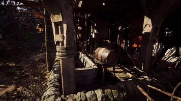 Ancient workshop with barrel and rustic tools in a weathered forest setting video