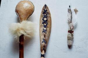 Shamanic objects. Tambourine beaters, a speaker's stick, noise makers. Ethnic Items photo