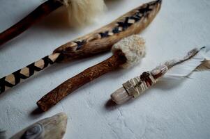 Shamanic objects. Tambourine beaters, a speaker's stick, noise makers. Ethnic Items photo