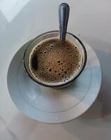 coffee drink in the middle glass on white background. Suitable for use when photographing people drinking coffee photo