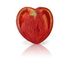 Heart shaped tomato close-up. Slice of lettuce tomato cut isolated on white background. photo