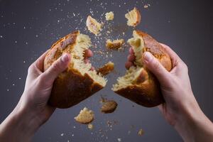 Two hands tearing bread highlight themes of sharing and connection photo