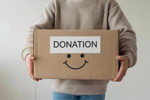 Cheerful face on donation box emphasizes giving with a clean background photo