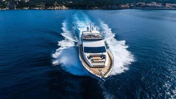Speeding Yacht on Open Sea Demonstrating Power and Grace with Majestic Water Trails Behind photo