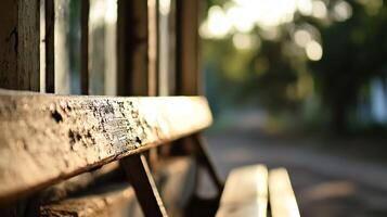 Rustic Sunlit Wooden Bench with Blurred Background Creating a Nostalgic Ambience photo