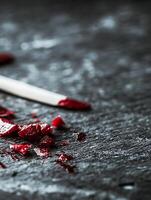 Artistic Smudged Red Chalk on Dark Slate Surface with Copy Space photo