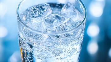 Closeup of refreshing sparkling water with ice and bubbles photo