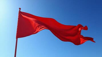 Bright Red Flag Waving Against a Clear Blue Sky Symbolizing Alertness and Warning Signals photo