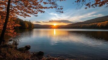 Serene Sunset over Mountain Lake with Autumn Foliage and Dramatic Sky photo