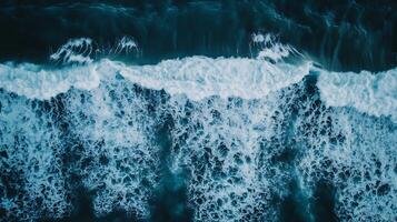 Aerial View of Crashing Ocean Waves with Turquoise Tones and White Foam Patterns photo
