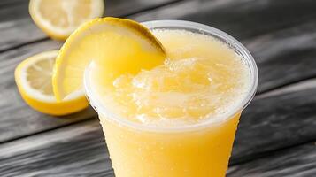 Refreshing frozen lemonade drink with citrus slice perfect for cooling down on a hot summer day photo