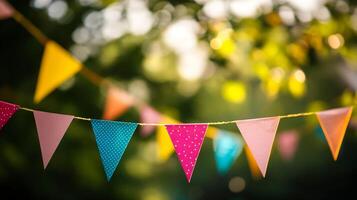 Cheerful colorful party bunting flags hanging in sunny garden creating festive atmosphere for events photo