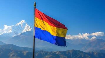 Vibrant Mountain Landscape with Colorful Flag and Snowcapped Peaks in Clear Blue Sky photo