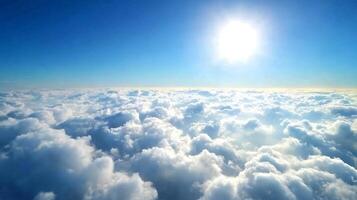 Breathtaking Aerial View of Fluffy Clouds Below Clear Blue Sky and Radiant Sunshine photo