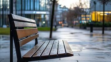 Serene Urban Scene with Empty Wooden Park Bench on Wet Rainy Street in Early Morning Light photo