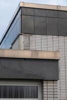Modern building showing different architectural elements and materials photo